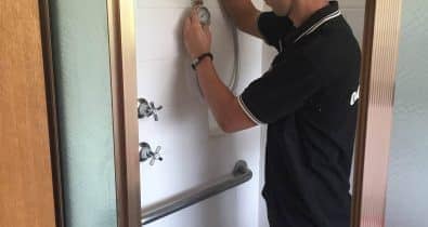 Water Tight Canberra plumber testing water pressure from the shower