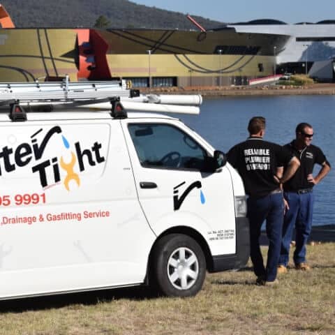two Water Tight Canberra team members with the company vehicle